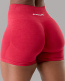 Red athletic shorts with 'Alphalete' branding on a gray background